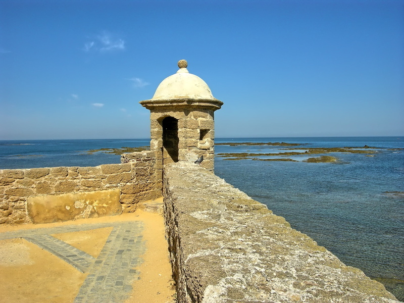 history, ramparts, sunlight, blue, architecture, tower, cadiz, no people, sky, day, fortress, direction, spain, horizon over water, building, sea, nature