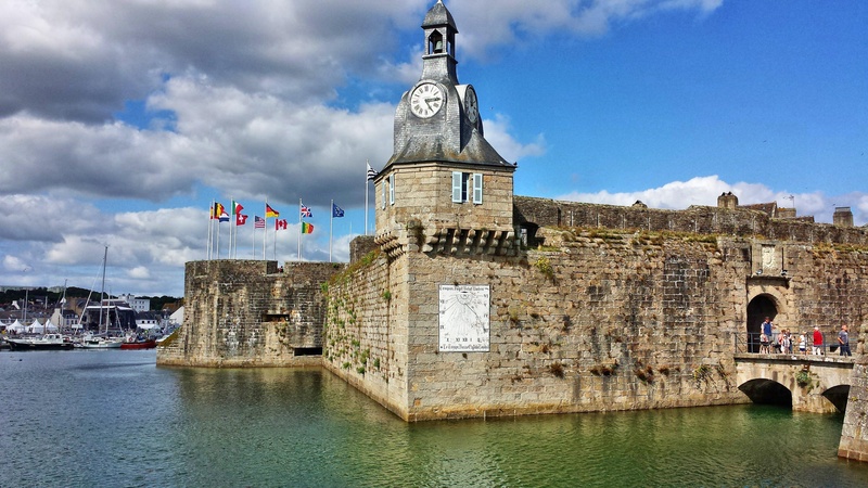 architecture, tourism, travel destinations, day, ramparts, tower, water, built structure, sky, the past, building exterior, waterfront, cloud - sky, belfry