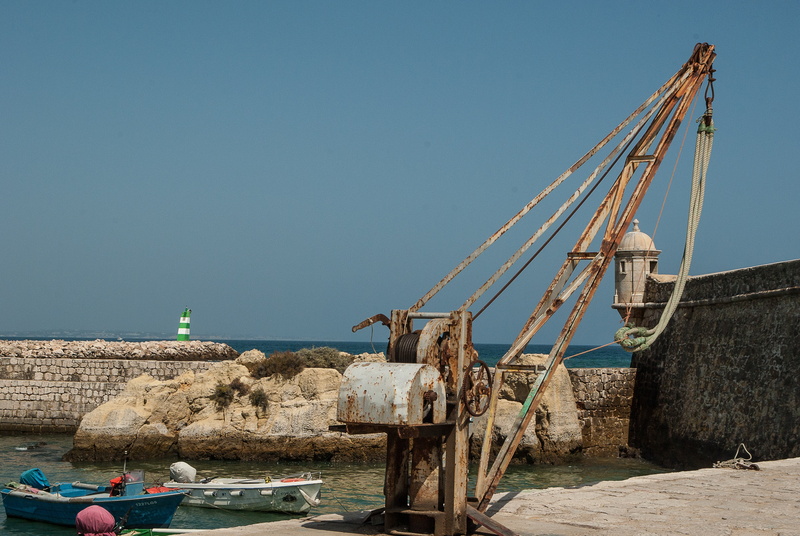 crane, nautical vessel, copy space, moored, transportation, built structure, fishing industry, beach, boats, sky, mode of transportation, day, sea, sunny