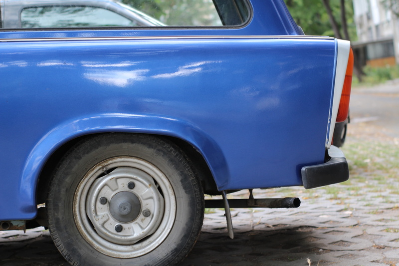 outdoors, timber, retro styled, mode of transportation, vintage car, street, white, close-up, motor vehicle, day, car, wheel, exhaust pipe, 5K, trabant