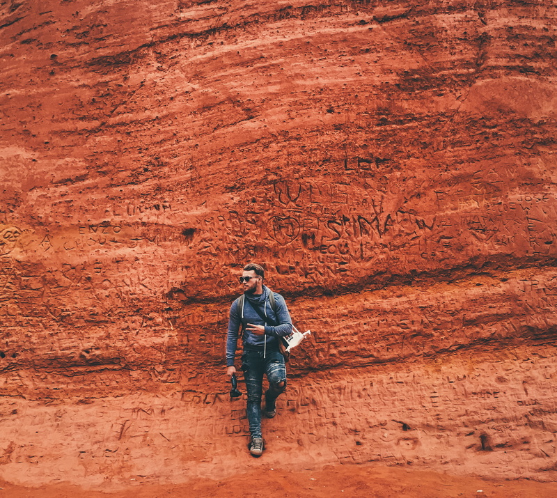 sunglasses, real people, hike, leisure activity, geology, full length, erosion, casual clothing, solid, rock, young men, young adult, barren, adult, standing