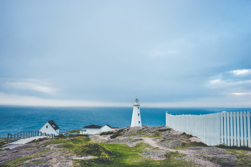 ocean, outdoors, building, safety, symbol, white, water, scenic, land, sky, blue, sea, direction, fence, guidance, historic, light, building exterior, nautical