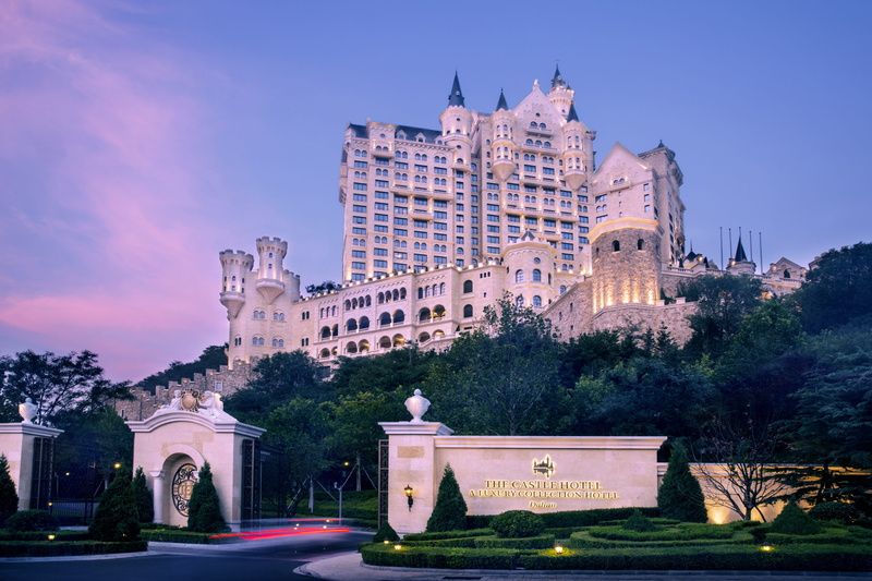 building exterior, tall buildings, dusk, castle, architecture, travel destinations, sky, built structure, the past, sea, history, nature, purple, city