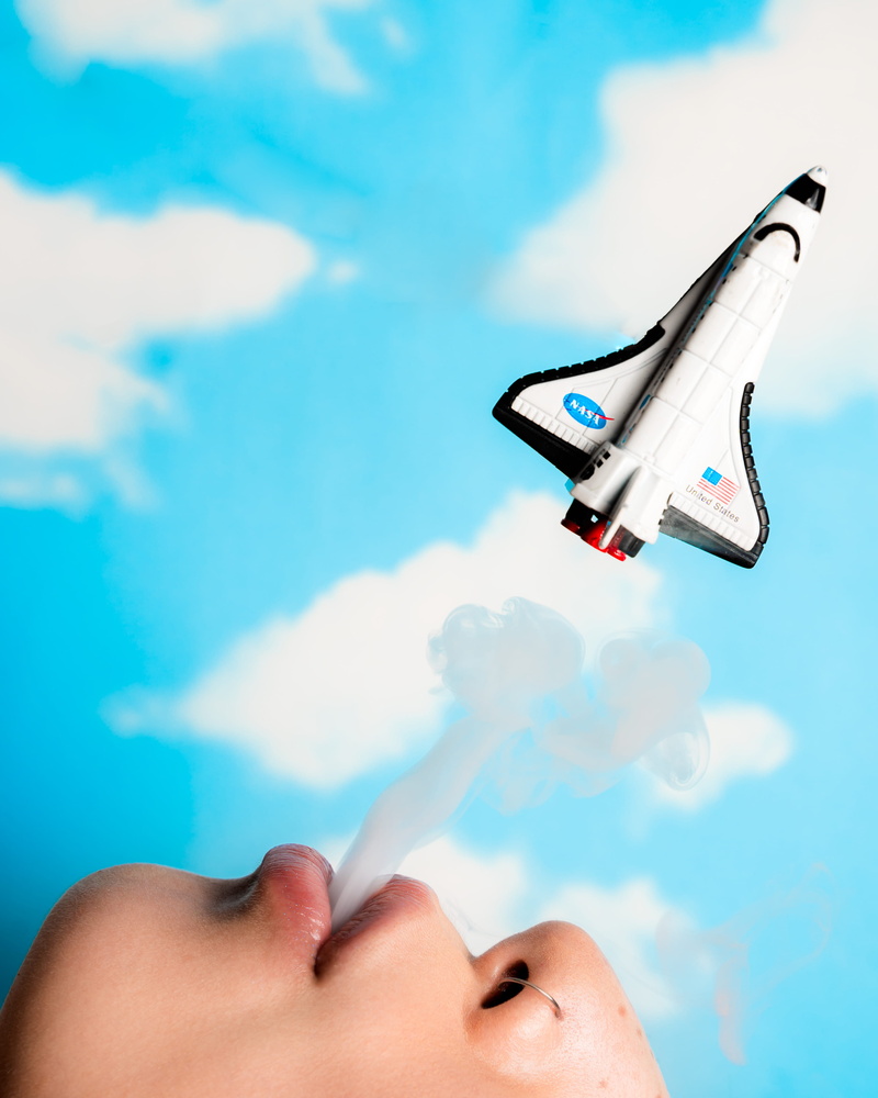 air vehicle, bird, leisure activity, flight, airliner, real people, finger, young adult, space shuttle, person, blue, low angle view, lifestyles, transportation