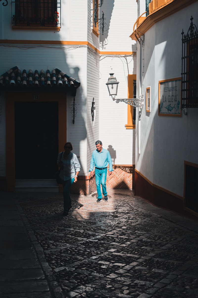 outdoors, walking, togetherness, lifestyles, rear view, 5K, building exterior, streetphotography, street, beside, direction, built structure, light, lightbeam