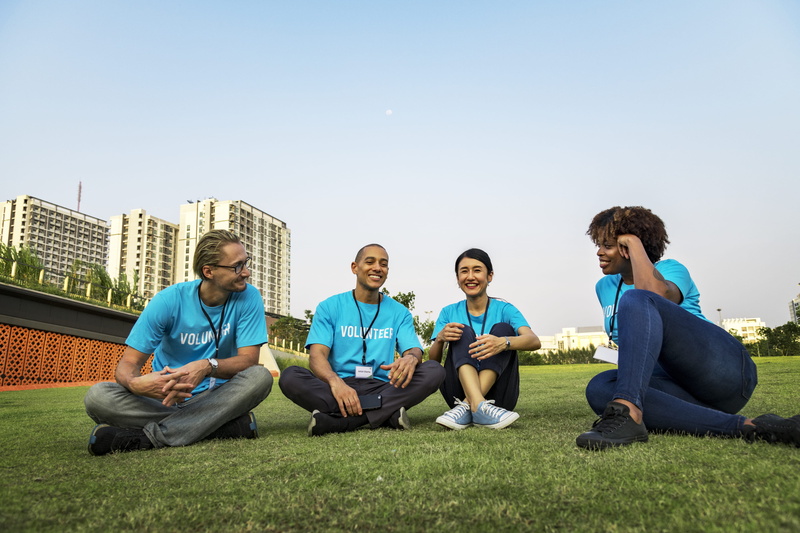 people, togetherness, friendship, adult, unity, grass, team, young men, cheerful, charity, full length, young adult, teamwork, blue, day, community service
