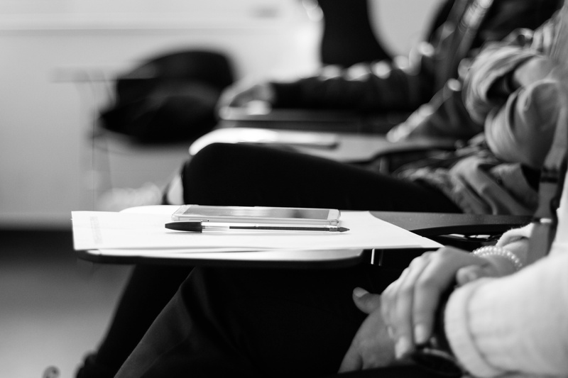 pen, grayscale, table, undershirt, hand, close-up, dish, corporate business, indoors, pens, sitting, couch, papers, focus on foreground, cafeteria, 5K