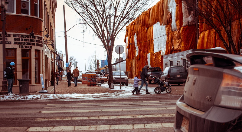 incidental people, bare tree, beside, stroller, built structure, land vehicle, road, day, crossing, outdoors, nature, snow, cold temperature, edmonton