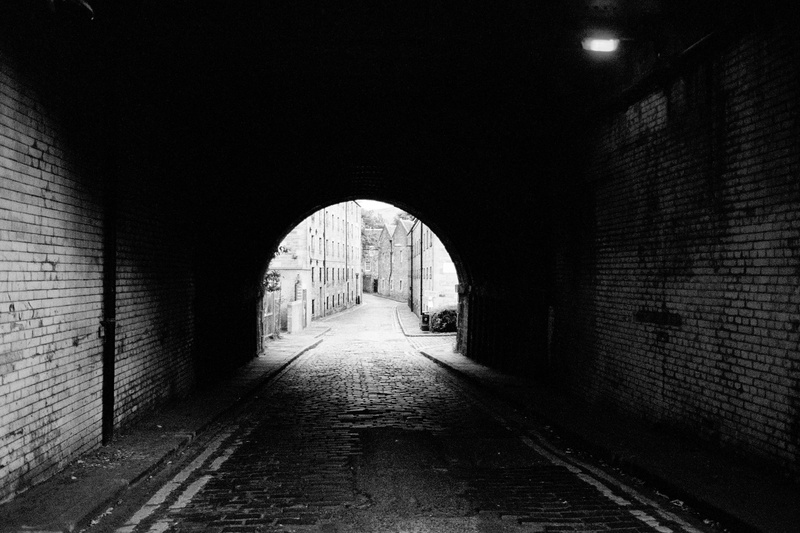 grayscale, alleyway, long, light at the end of the tunnel, brick, dome, concrete, building, indoors, alley, cobblestone, brick wall, photography, no people