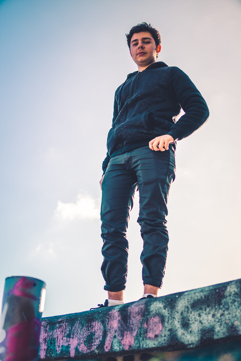 looking at camera, shoe, denim, long, riding boot, day, sleeve, nature, young adult, leisure activity, shirt, real people, clothing, low angle view, sky