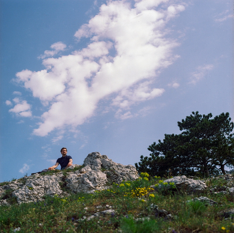 real people, adventure, backpacking, active, happy, summer, rock, tourism, leisure activity, healthy, sitting, tree, low angle view, sport, person, cloud - sky