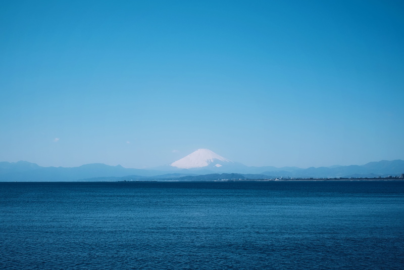 land, blue sea, water, nature, idyllic, non-urban scene, mt fuji, scenery, beauty in nature, shoreline, tranquility, japan, coast, mountain peak, sky, sea