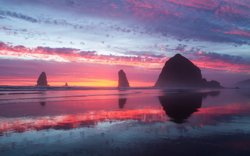 waterfront, orange color, tranquil scene, sunset, silhouette, shore, reflection, beauty in nature, idyllic, outdoors, sky, tranquility, no people, stack rock