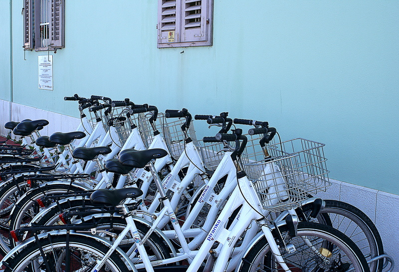 bicycle parking, outdoors, bicycle, blue, city, in a row, means of communication, nut, mode of transportation, the background, building, built structure