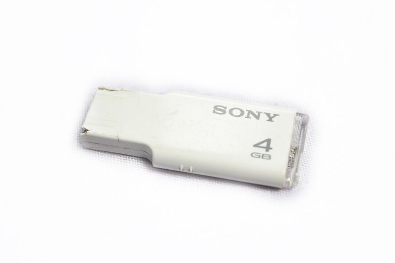 western script, number, technology, sri lanka, still life, sony, business, storage, cut out, high angle view, pendrive, white color, communication, no people