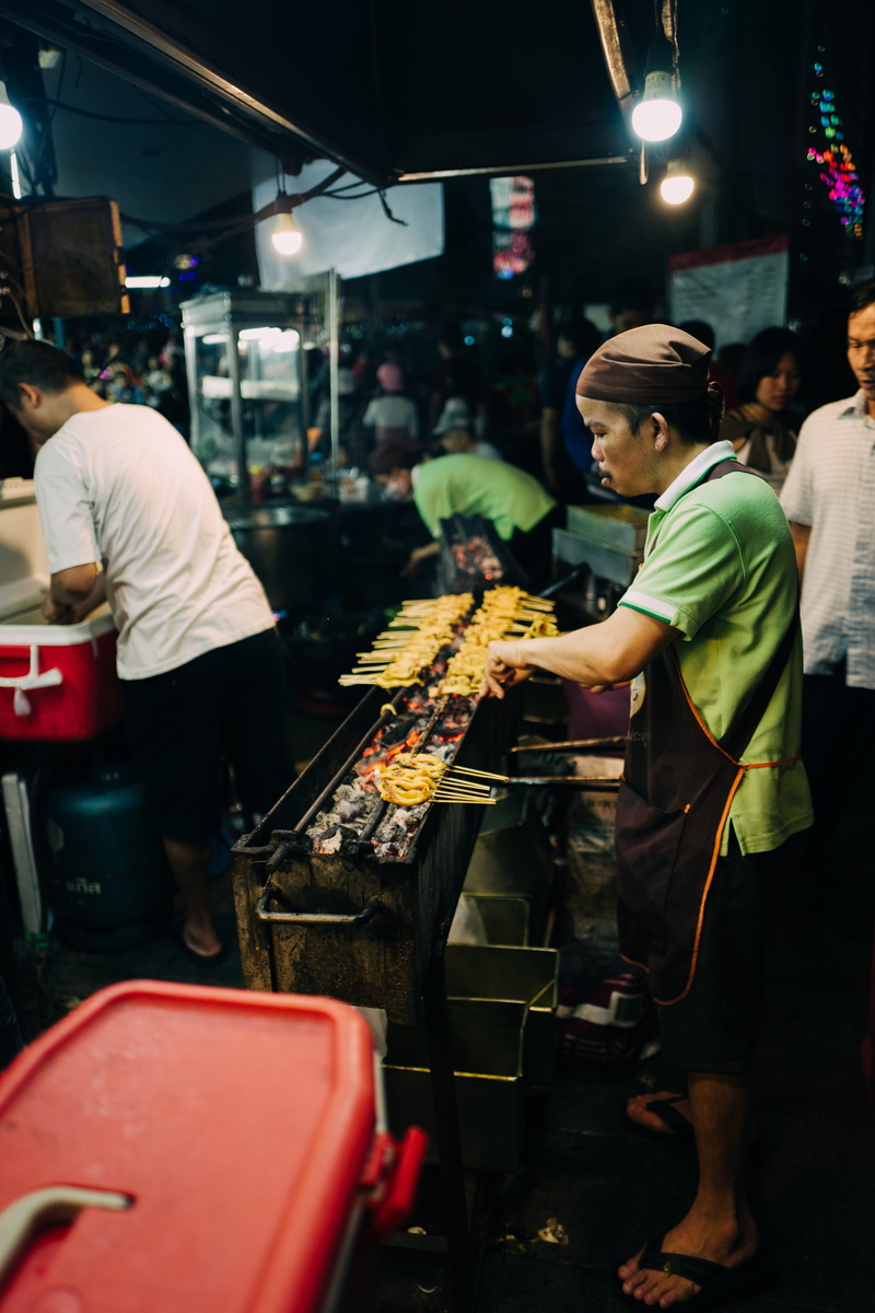 illuminated, old, night, market, time, arts culture and entertainment, foods, women, business, skill, indoors, outdoor, adult, occupation, female, grilling