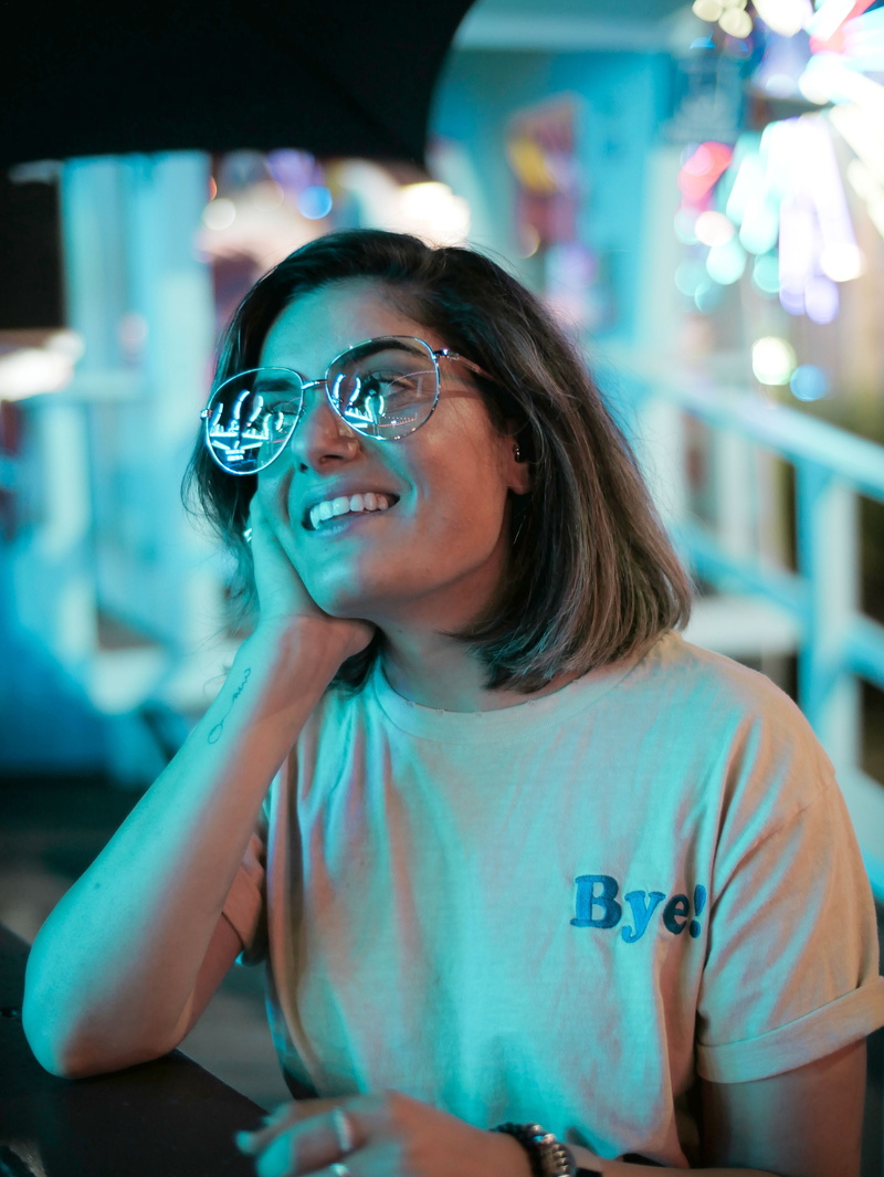 one person, women, hand, hairstyle, real people, fair, festival, neon light, putting, smile, watching, young women, cheek, teeth, tattoo, music, young adult
