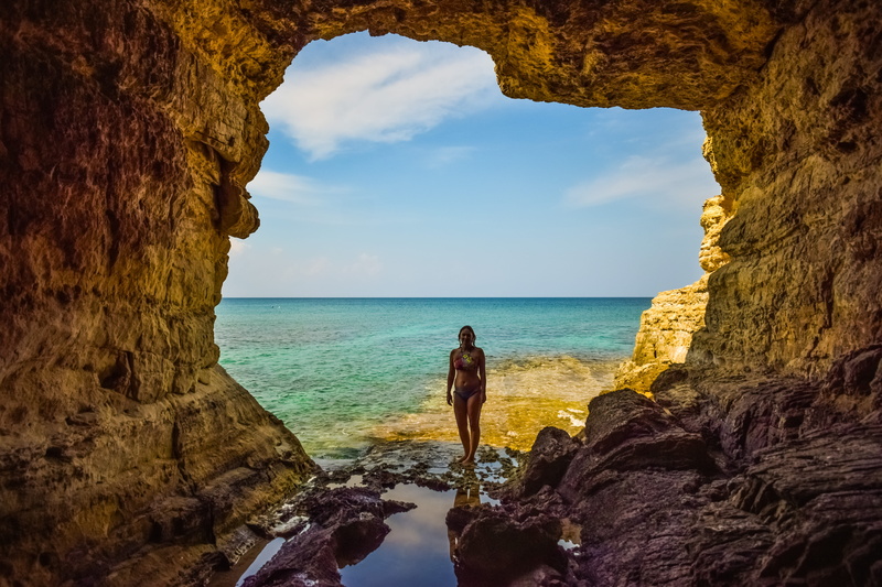 natural arch, standing, girl, sea, scenics - nature, geology, outdoors, leisure activity, sea cave, rock, cyprus, coast, arch, water, rock formation, lifestyles