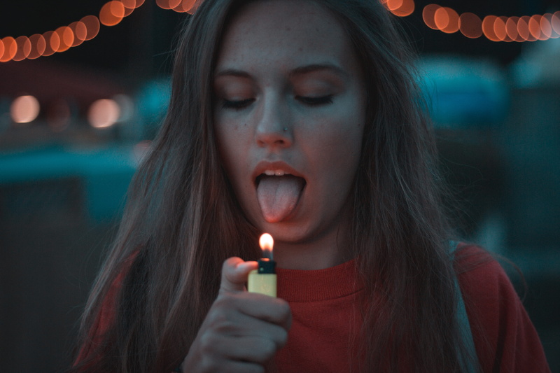 flame, festival, close-up, hairstyle, adult, holding, woman, long hair, tongue, one person, schwarzwald, lighting, yellow, red, lowlight, germany, human body part