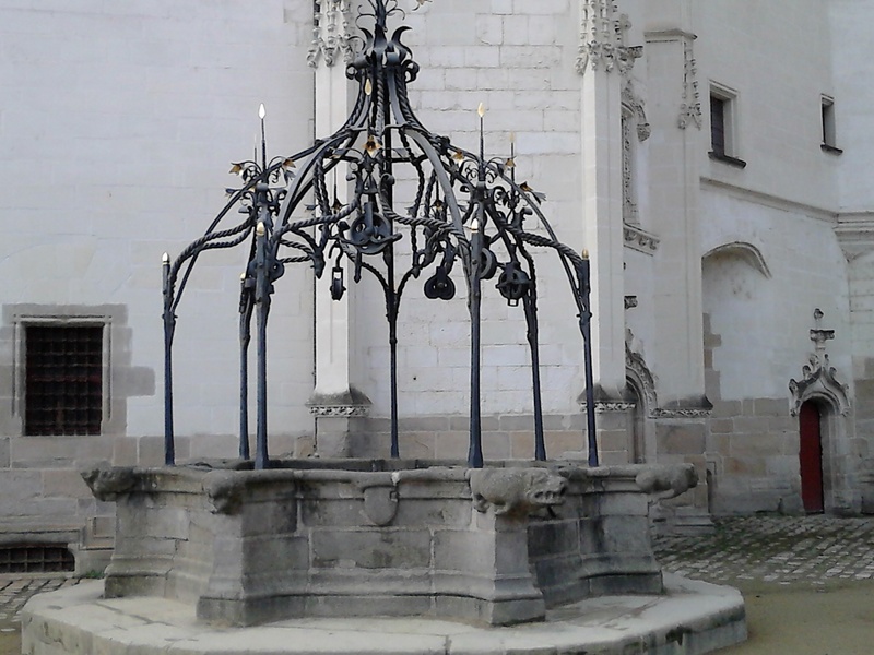 built structure, religion, building exterior, metalwork, lighting equipment, history, no people, day, city, spirituality, architectural column, sculpture