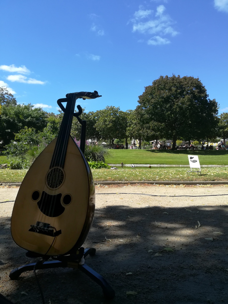 green color, concert, mike, shadow, cloud - sky, blue, arabic intrument, oud, arab, sky, outdoors, botanical garden, park - man made space, no people, land