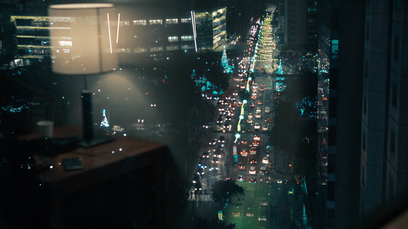 light, metropolis, window, architecture, building, vehicle, financial district, built structure, outdoors, cityscape, no people, skyscraper, scenery, flare