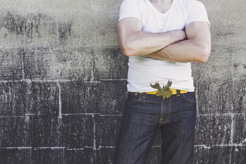person, white, one person, moose, front view, outdoors, daytime, only men, belt, midsection, cross arms, men, vneck, arms crossed, neck, leisure activity