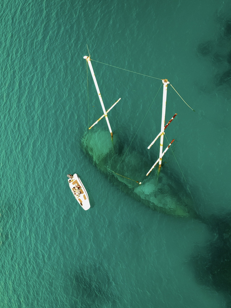 outdoors, beauty in nature, white, nature, sea, sunlight, view, waterfront, day, aerial view, mode of transportation, shipwreck, photography, transportation