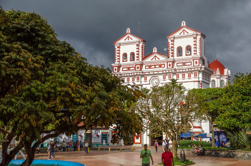 plant, Colombia, cloud - sky, sky, Guatape, spirituality, travel destinations, plaza, incidental people, church, religion, built structure, belief, building exterior