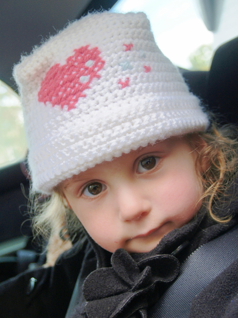 sitting, kid, crochet, child, daughter, clothing, human face, day, headshot, portrait, looking at camera, little girl, solemn, hat, expression, heart, car seat