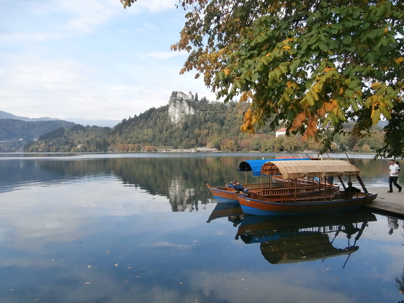 mountain, day, tranquil scene, beauty in nature, moored, plant, tranquility, waterfront, sky, lake, nautical vessel, non-urban scene, reflection, no people