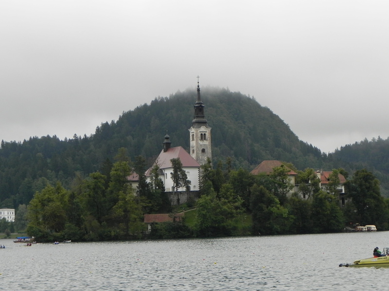 island, 2K, slovenia, no people, built structure, lake, bled, tree, plant, religion, mountain, mode of transportation, fog, day, outdoors, castle, architecture