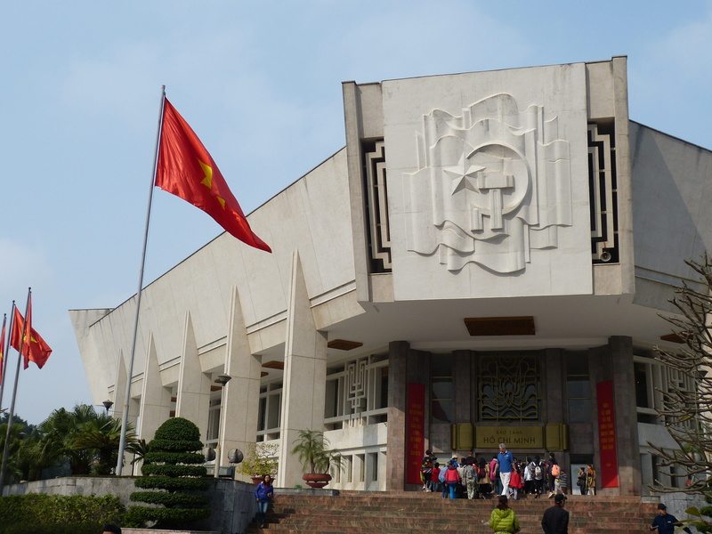 men, city, women, parliament, group of people, built structure, flag, real people, patriotism, tree, red, policy, architecture, building exterior, nature