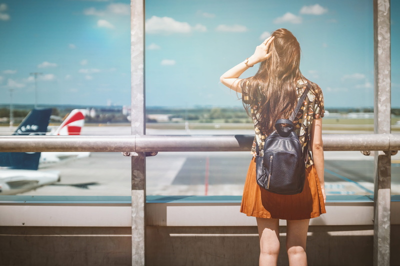 standing, airport, female, beginning, leisure activity, young, rear view, 4K, vacation, real people, fashion, young adult, water, three quarter length