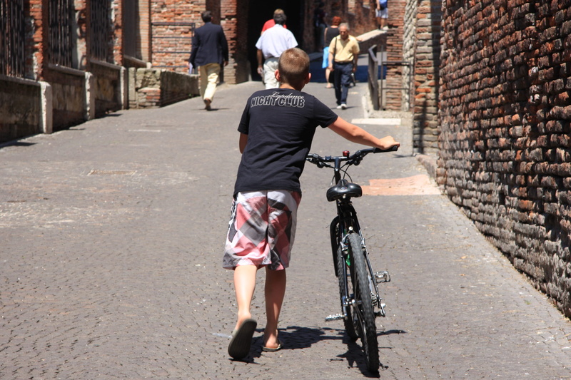 bicycle, rear view, riding, casual clothing, motion, slide, uphill, full length, day, street, 4K, go, brick, real people, architecture, outdoors, ride