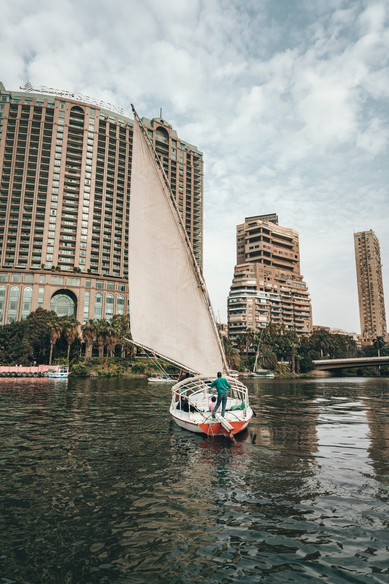 skyscraper, office building exterior, built structure, africa, sailing, blogger, river, passenger craft, man, sail, calm, person, outdoors, nile river