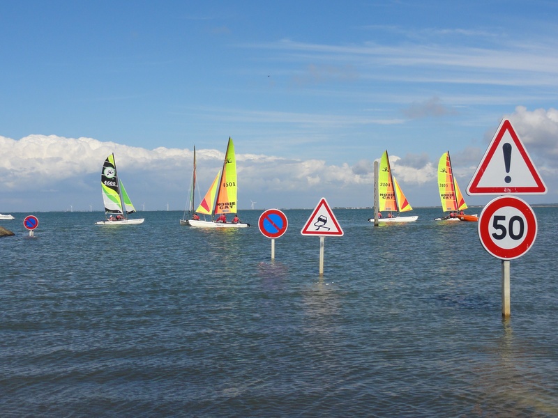 sky, multi colored, road sign, scenics - nature, sign, capital letter, nautical vessel, text, boat, sea, panel, catamaran, water, waterfront, day, transportation
