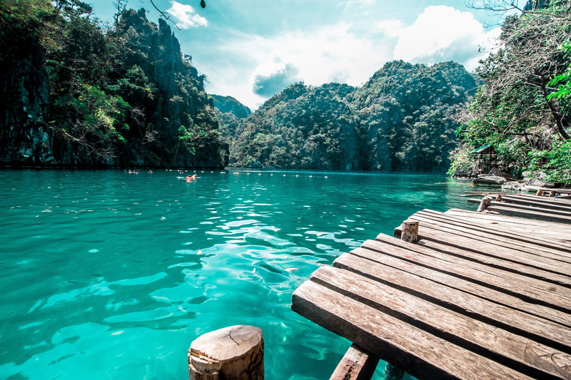 women, water, tourist, bridge, sun, lake, resort, scenics - nature, body, vacation, ocean, cloud - sky, wooden raft, tree, trip, brown, tourism, paradise