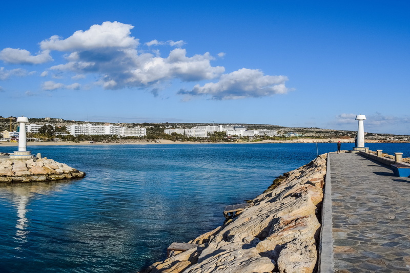beach, built structure, cloud - sky, day, harbor, rock, city, stone wall, building, architecture, sea, sky, solid, water, blue, ayia napa, nature, rock - object