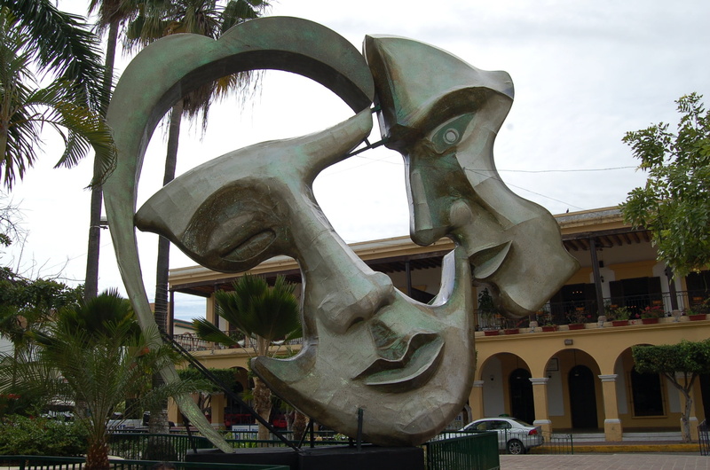 built structure, day, sky, face, mazatlan, architecture, representation, palm tree, near, mexico, tree, human representation, incidental people, building exterior
