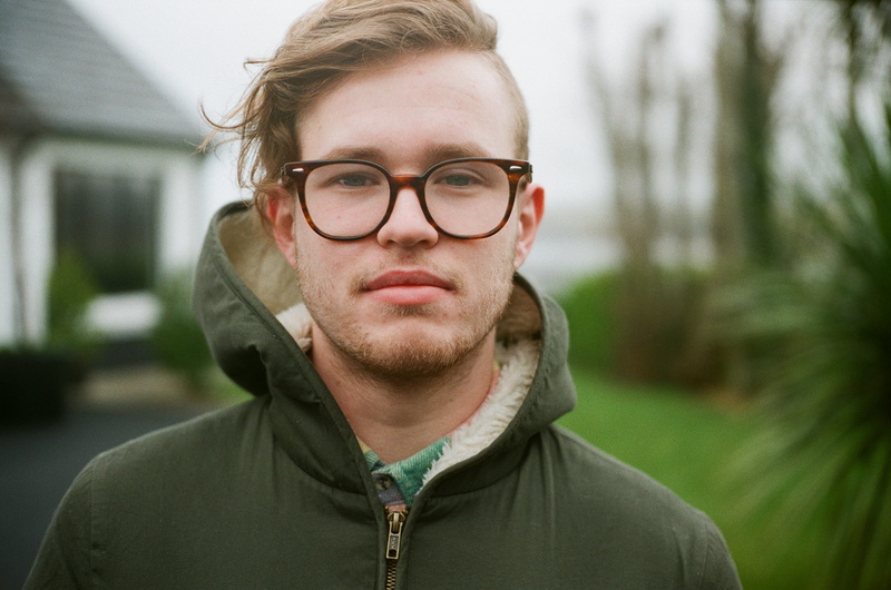 outdoors, front view, glasses, day, casual clothing, confidence, mid adult, focus on foreground, united kingdom, ballycastle, man, headshot, looking at camera