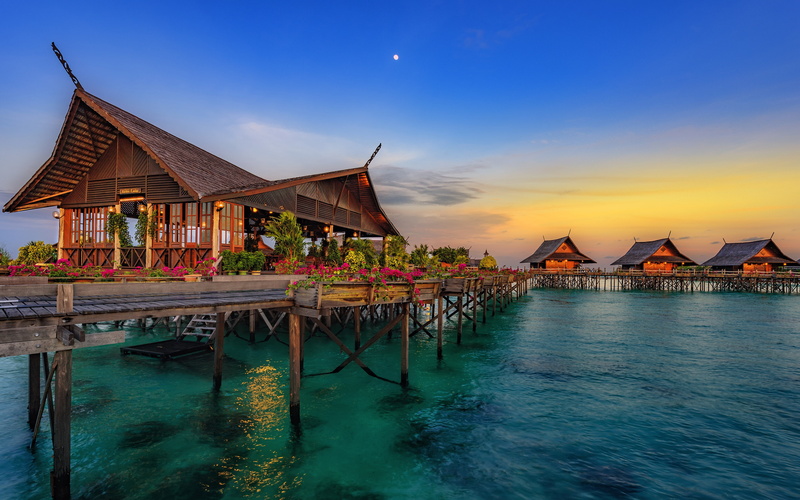 outdoors, blue, sunset, resort, reflection, beauty in nature, building, sky, architecture, built structure, hainan, stilt house, turquoise colored, house