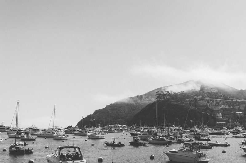 bay, no people, nautical vessel, outdoors, island, anchored, mode of transportation, black and white, beach, speedboat, ocean, coast, nature, moored, lot