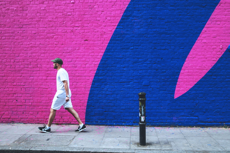 man, east, brick wall, wall - building feature, walks, wall, standing, adult, people, casual clothing, footpath, architecture, full length, leisure activity