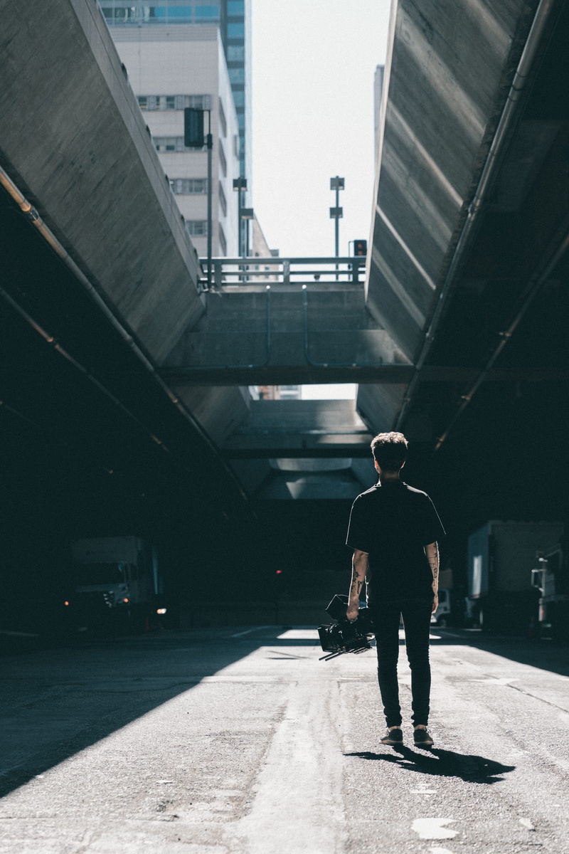 building exterior, transportation, standing, rear view, men, building, sunlight, city, caucasian, walking, adult, lifestyles, 5K, guy, man, day, one Person