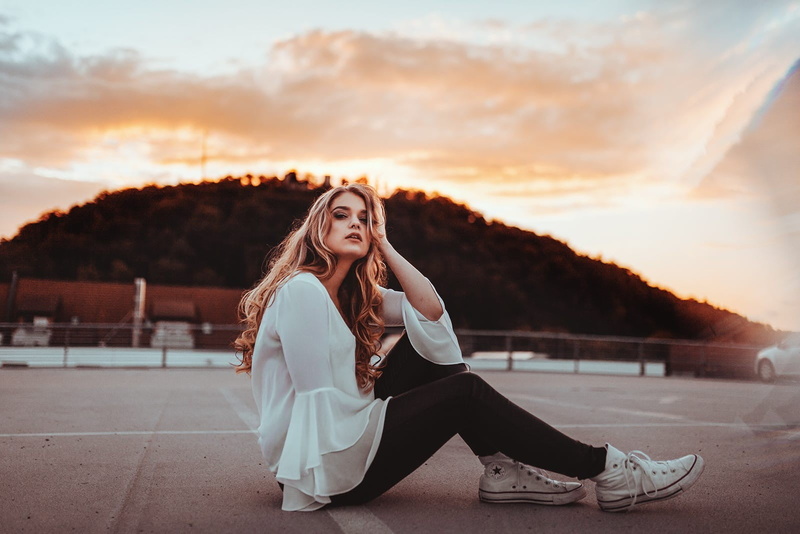 shoe, sunset, sitting, young adult, lifestyles, leisure activity, legs, portrait, young women, full length, looking at camera, real people, fashion, sky