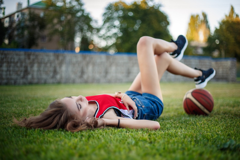 nature, depth of field, relaxation, women outdoors, sports jerseys, plant, casual clothing, soccer, child, grass, 2K, real people, lying on back, jean shorts