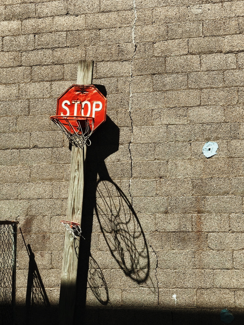 wall, lean, sign, land vehicle, red, architecture, transportation, stop, no people, day, mode of transportation, brown, brick, capital letter, urban, bicycle
