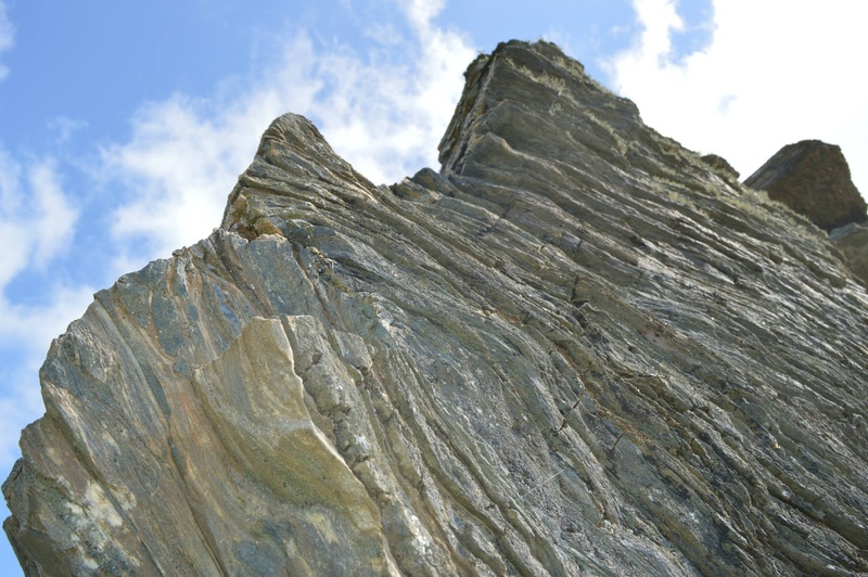 mountain peak, rock - object, cliff, tranquility, cloud - sky, formation, non-urban scene, beauty in nature, mountain, geology, rock formation, solid, outdoors