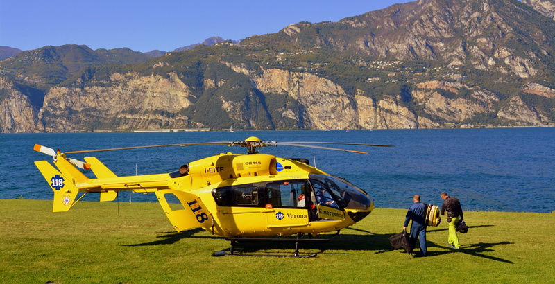 sea, mountain range, leisure activity, helicopter, sky, nautical vessel, transportation, day, land, rescue, water, mode of transportation, beach, yellow